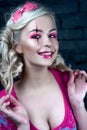 Beautiful blonde girl with two pigtails, with creative doll make-up: pink glossy lips, wearing pink skeleton dress. for the Hallow Royalty Free Stock Photo