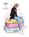 Beautiful blonde hair woman sitting on suitcases. Fashion girl in sunglasses.
