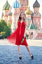 Beautiful blonde lady in red dress on Red Square