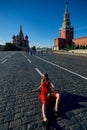 Beautiful blonde lady in red dress on Red Square