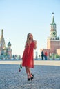 Beautiful blonde lady in red dress on Red Square