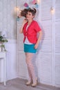 Blonde model in white stockings and green miniskirt  posing in studio Royalty Free Stock Photo