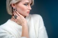 Beautiful blonde with luxurious silver jewelry. Woman wears silver jewelry