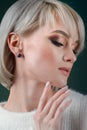 Beautiful blonde with luxurious silver jewelry. Woman wears silver jewelry