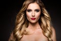 Beautiful blonde model girl with long curly hair . Hairstyle wavy curls . Red lips.