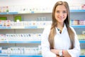 Beautiful blonde pharmacist in drugstore or pharmacy smiling Royalty Free Stock Photo