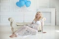 Beautiful blonde pregnant woman smiling and touching her belly i Royalty Free Stock Photo