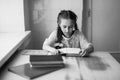 Beautiful blonde schoolgirl with books in the school Royalty Free Stock Photo