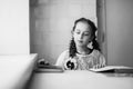 Beautiful blonde schoolgirl with books in the school Royalty Free Stock Photo