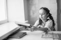 Beautiful blonde schoolgirl with books in the school Royalty Free Stock Photo