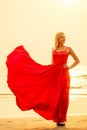 Beautiful blonde sensual glamour passion desire sexuality woman in flying red butterfly silk dress sea and tropical