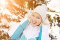 Beautiful blonde smiling girl adjusting her hat