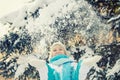 beautiful blonde smiling girl throws up the snow that beautifully falls down Royalty Free Stock Photo