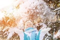 Beautiful blonde smiling girl throws up the snow that beautifull Royalty Free Stock Photo