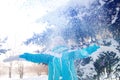 Beautiful blonde smiling girl throws up the snow Royalty Free Stock Photo