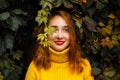 Beautiful girl walking outdoors in autumn park. Smiling Young woman enjoying autumn weather. Royalty Free Stock Photo