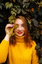 Beautiful girl walking outdoors in autumn park. Smiling Young woman enjoying autumn weather. Royalty Free Stock Photo