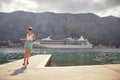 Beautiful blonde tourist on dock running in casual clother. Summer holiday fun and freedom, feeling carefree. Travel, leisure, fun