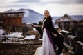 Beautiful blonde Viking dressed in a black cloak against the backdrop of the castle Royalty Free Stock Photo