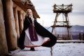 Beautiful blonde Viking dressed in a black cloak against the backdrop of the castle Royalty Free Stock Photo