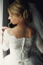 Beautiful blonde wedding bride in make-up and veil in a white dr Royalty Free Stock Photo