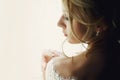 Beautiful blonde wedding bride in make-up and veil in a white dr Royalty Free Stock Photo