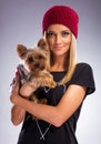 Beautiful blonde woman in autumn dress, holding a yorkshire terrier dog Royalty Free Stock Photo