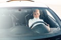 Beautiful fashionable blonde woman behind the wheel of a white car Royalty Free Stock Photo