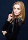 Beautiful blonde woman in black velvet dress with epulet Royalty Free Stock Photo