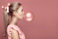 Beautiful blonde woman blowing gum. Fashion portrait