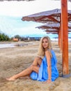Beautiful blonde woman posing on an empty sea beach Royalty Free Stock Photo