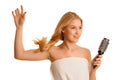 Beautiful blonde woman brushing her hair as a sign og hair care Royalty Free Stock Photo