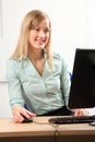 Beautiful blonde woman busy at office computer Royalty Free Stock Photo