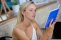 beautiful blonde woman in cafe reading book