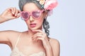 Beautiful blonde woman with a cake. Sweet lady with heart glasses. Vintage style. Fashion photo with copy space Royalty Free Stock Photo