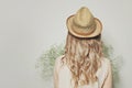 Beautiful blonde woman with curly hair wearing a summer hat, female back Royalty Free Stock Photo