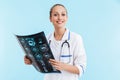 Beautiful blonde woman doctor wearing uniform standing Royalty Free Stock Photo