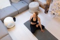 Beautiful blonde woman doing home workout indoors. Woman practice yoga at home. Fit girl using workout tutorials for