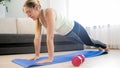 Beautiful blonde woman doing push-ups on floor at home Royalty Free Stock Photo