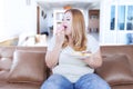 Beautiful blonde woman eating donuts Royalty Free Stock Photo