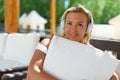 Beautiful blonde woman enjoying music outdoors. Royalty Free Stock Photo