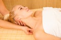 Beautiful blonde woman enyoing massage treatment in sap salon Royalty Free Stock Photo