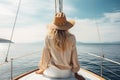 blonde woman with hat sits on a yacht and enjoys the summer holiday over the tropical ocean, AI Generated Royalty Free Stock Photo