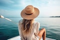 blonde woman with hat sits on a yacht and enjoys the summer holiday over the tropical ocean, AI Generated Royalty Free Stock Photo