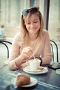 Beautiful blonde woman having breakfast at the bar Royalty Free Stock Photo