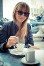 Beautiful blonde woman having breakfast at the bar Royalty Free Stock Photo