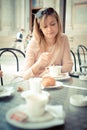 Beautiful blonde woman having breakfast at the bar Royalty Free Stock Photo