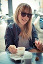 Beautiful blonde woman having breakfast at the bar Royalty Free Stock Photo