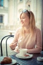 Beautiful blonde woman having breakfast at the bar Royalty Free Stock Photo