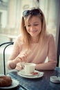 Beautiful blonde woman having breakfast at the bar Royalty Free Stock Photo